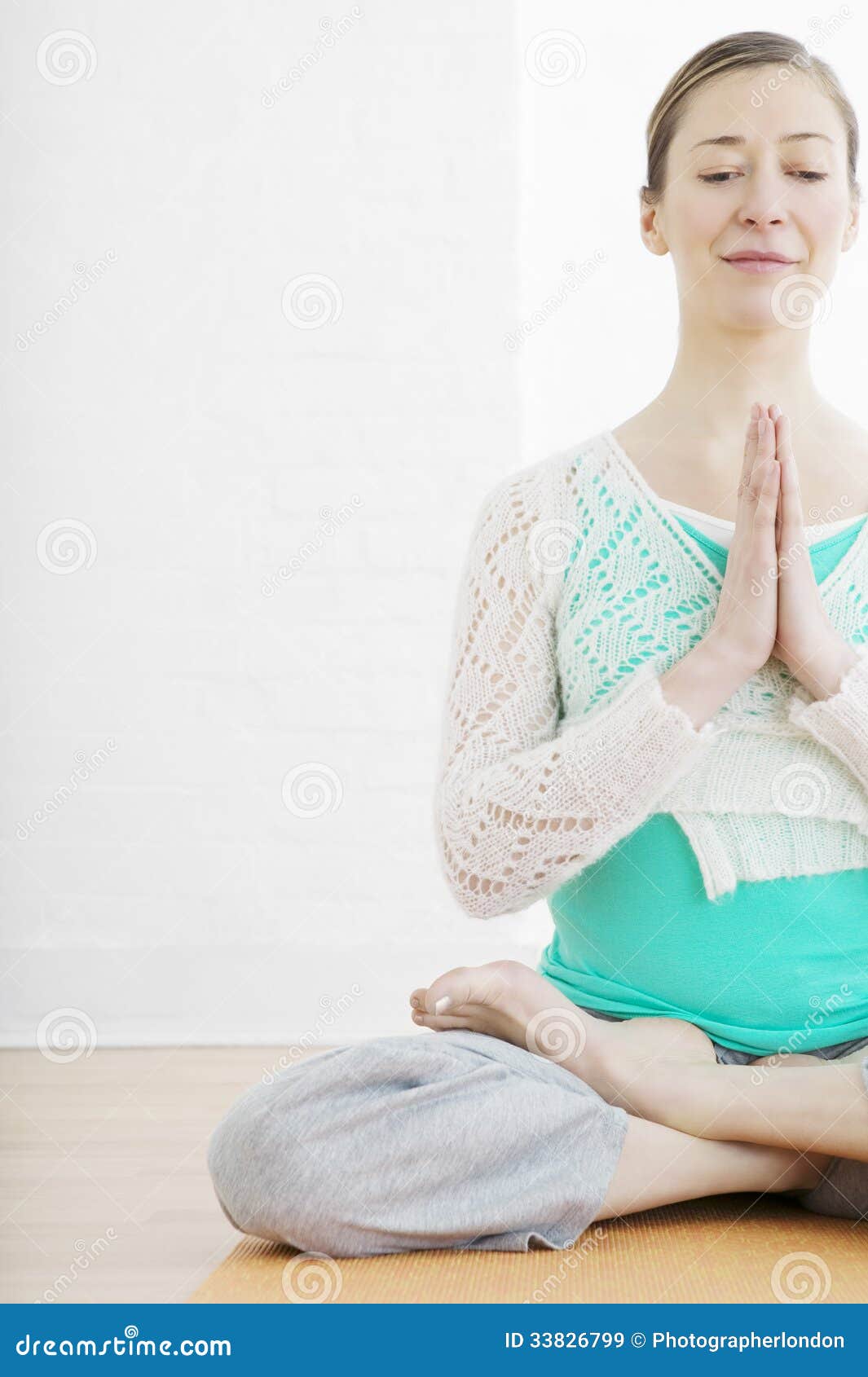 Woman Sitting Cross Legged in a Yoga Pose Stock Image - Image of exercise,  people: 33826799