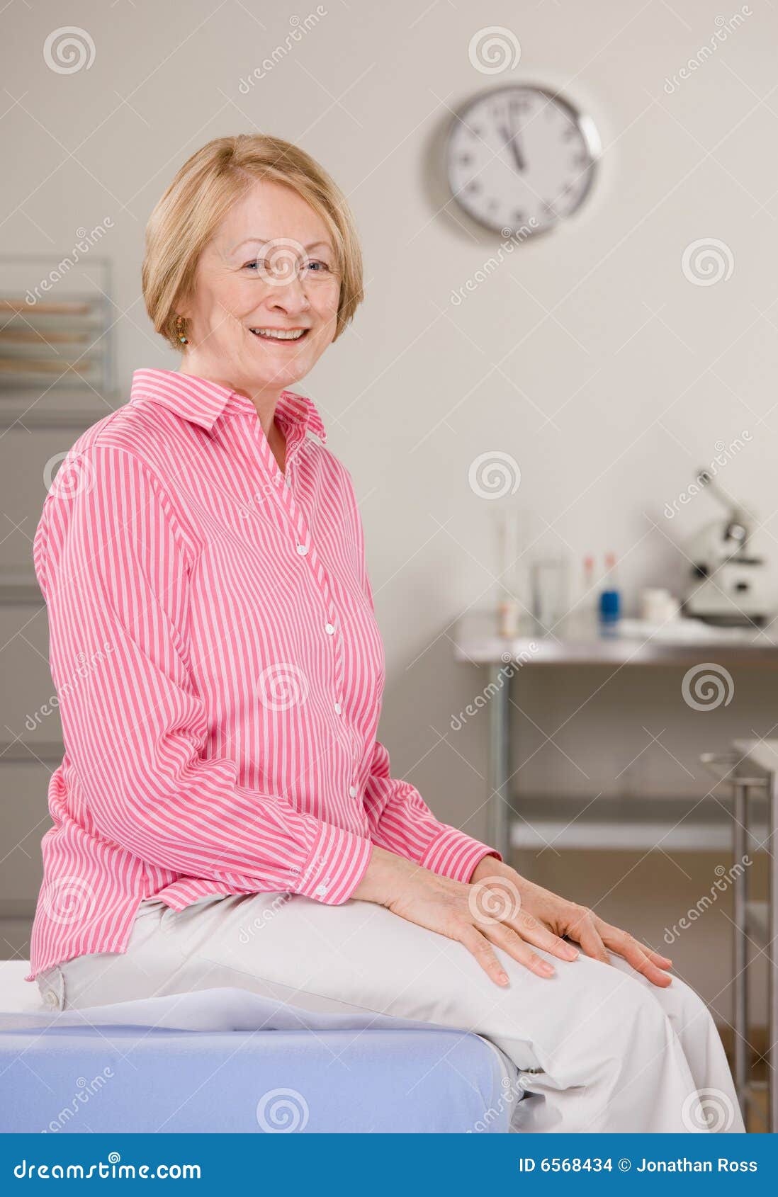 woman sitting on exam table during checkup