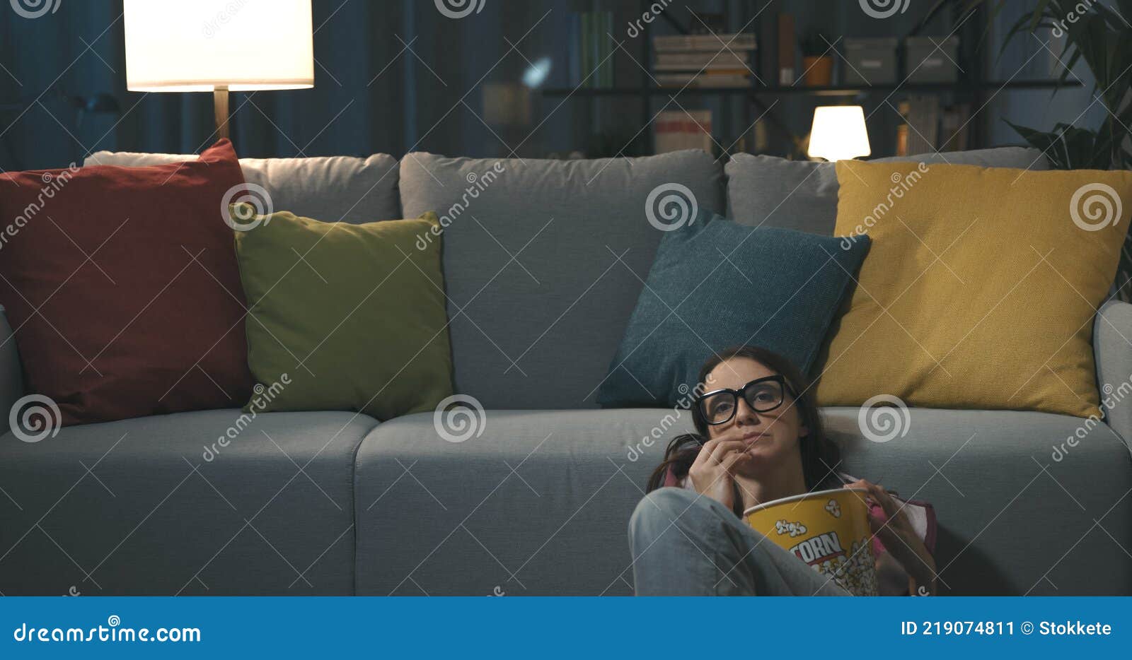 woman sitting on the floor and watching tv
