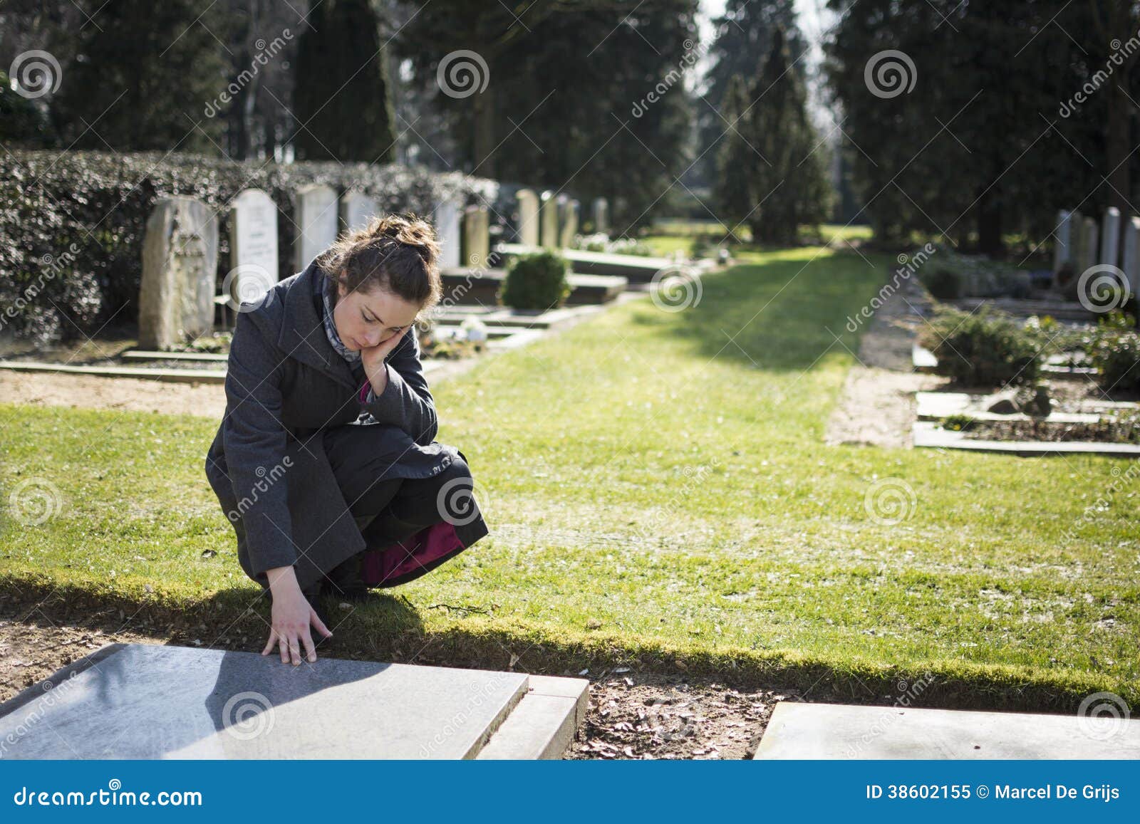 woman sitting at grave