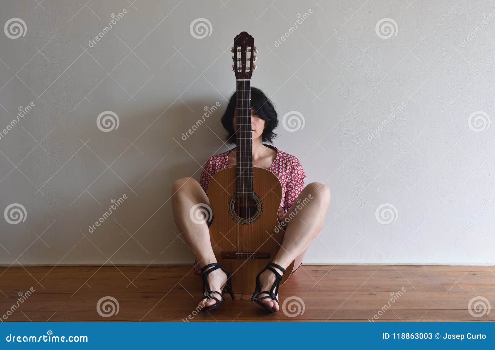 woman sitting with a guitar