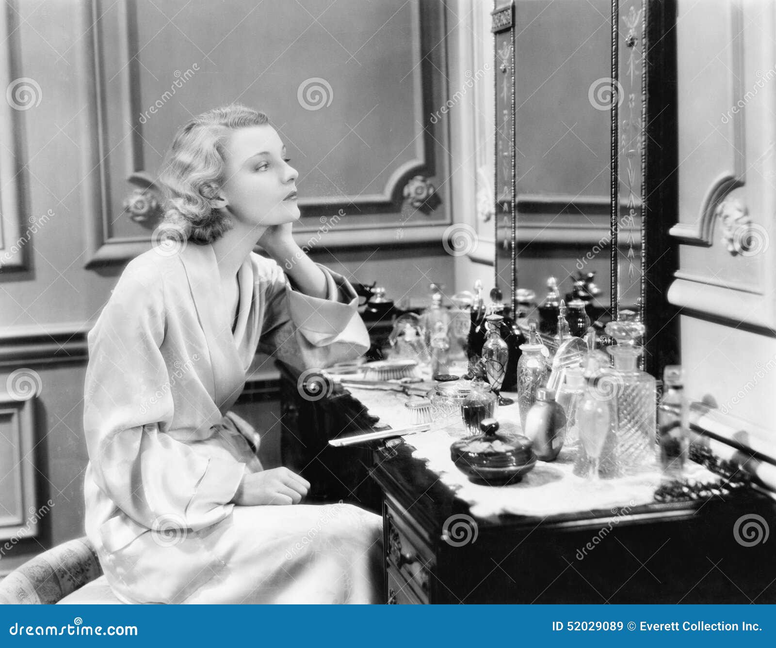 woman sitting at her vanity looking into the mirror