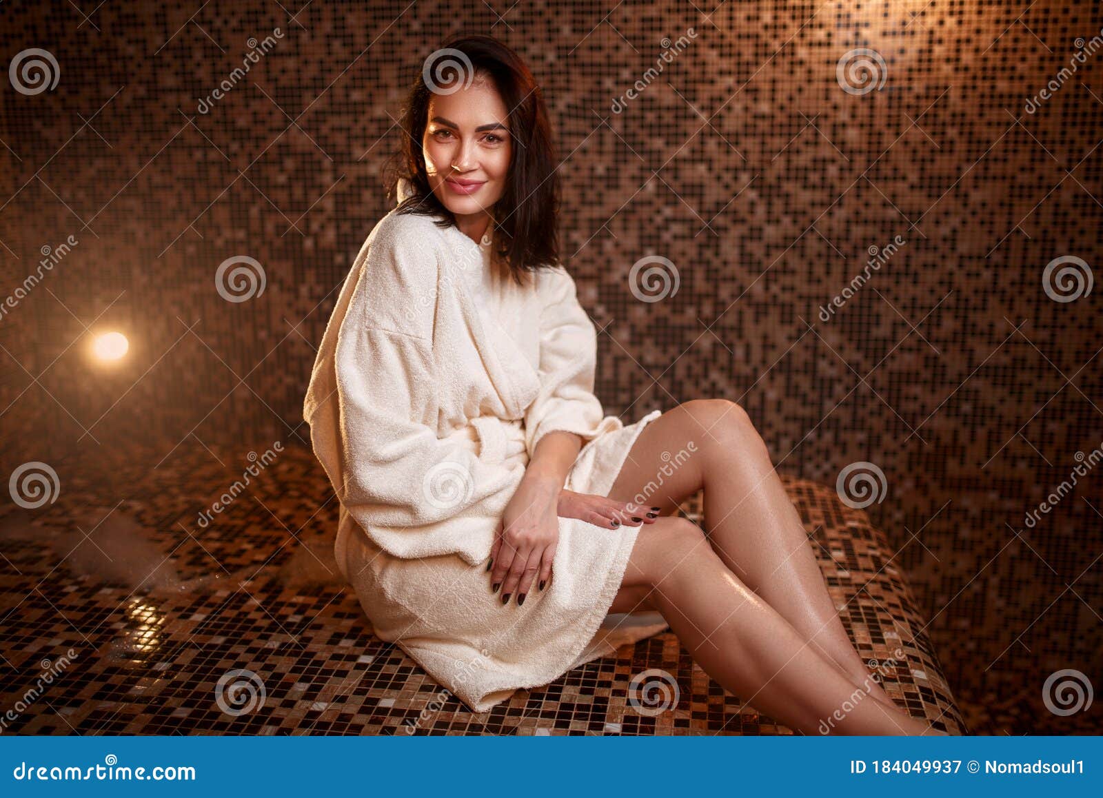 woman sitting on a hot stone in hamam, sauna