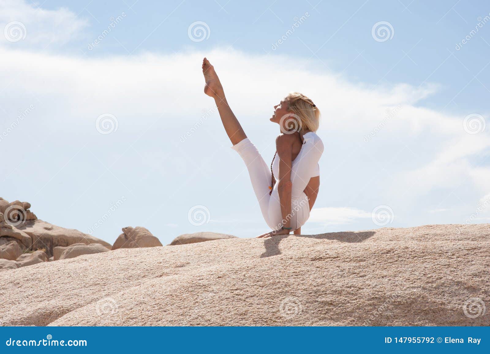 Beautiful slim woman in sports overalls doing yoga, standing in an asana  pose - compass position sitting one foot behind head on white isolated back  Stock Photo - Alamy