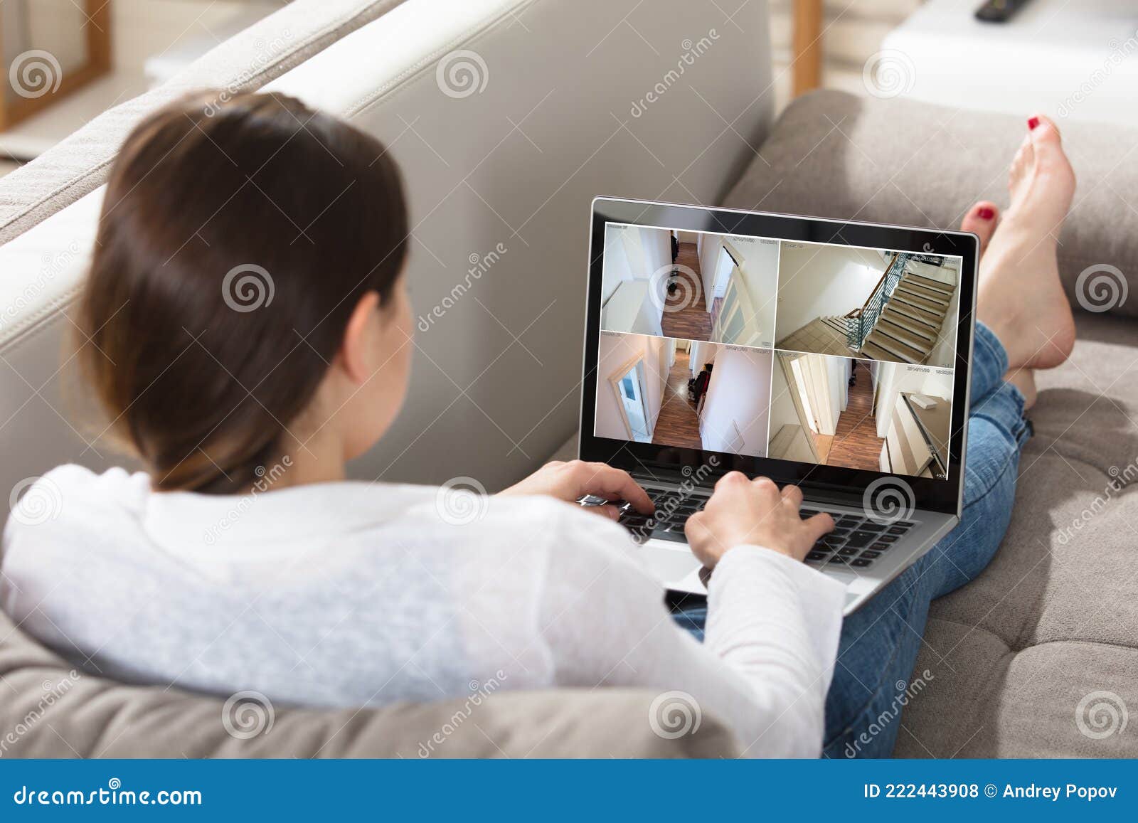woman monitoring cctv footage on laptop