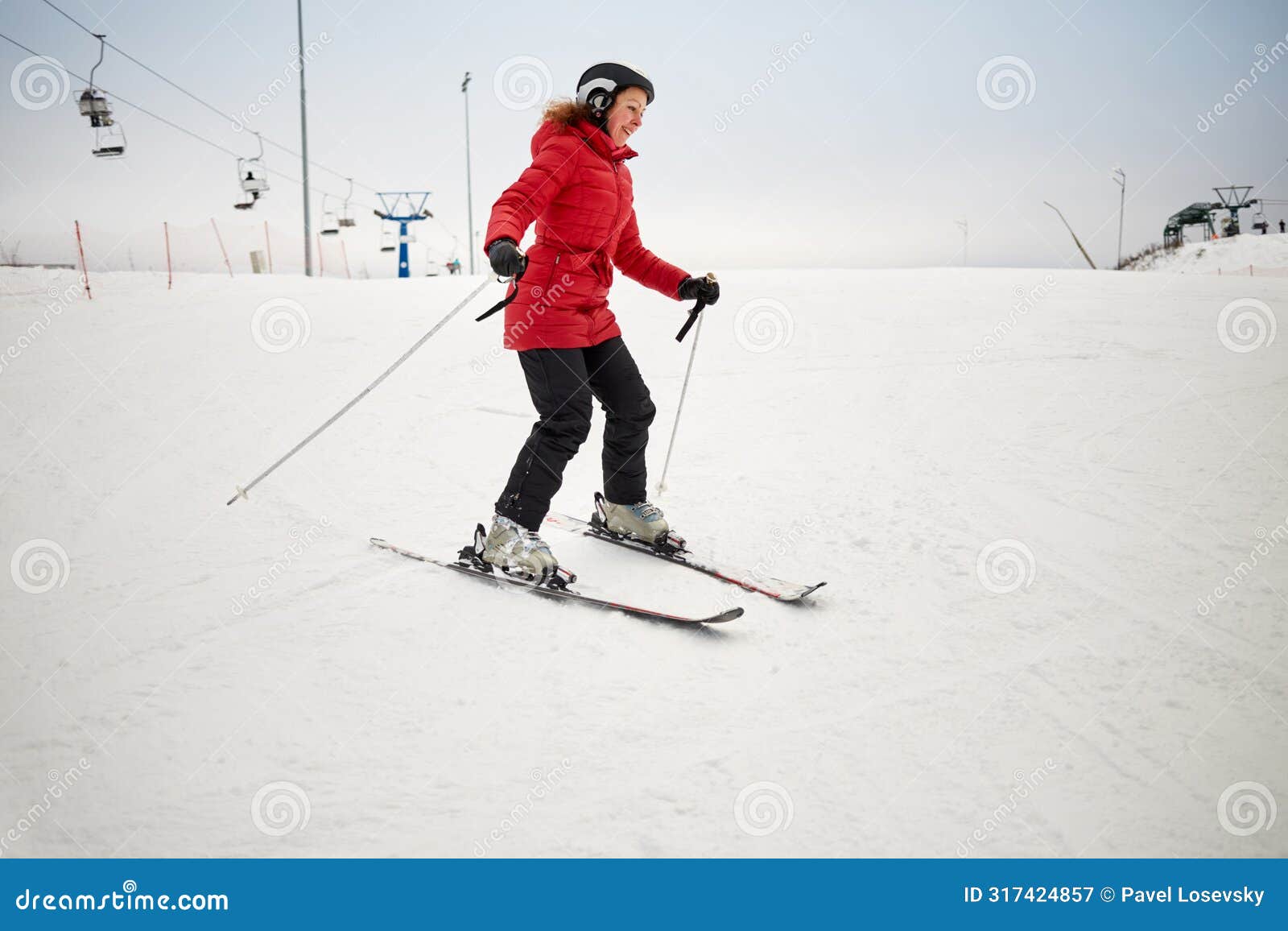 woman skis on slope in winter day at sports