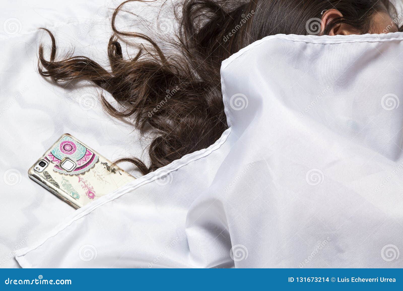 woman sleeping with phone in bed. latin woman