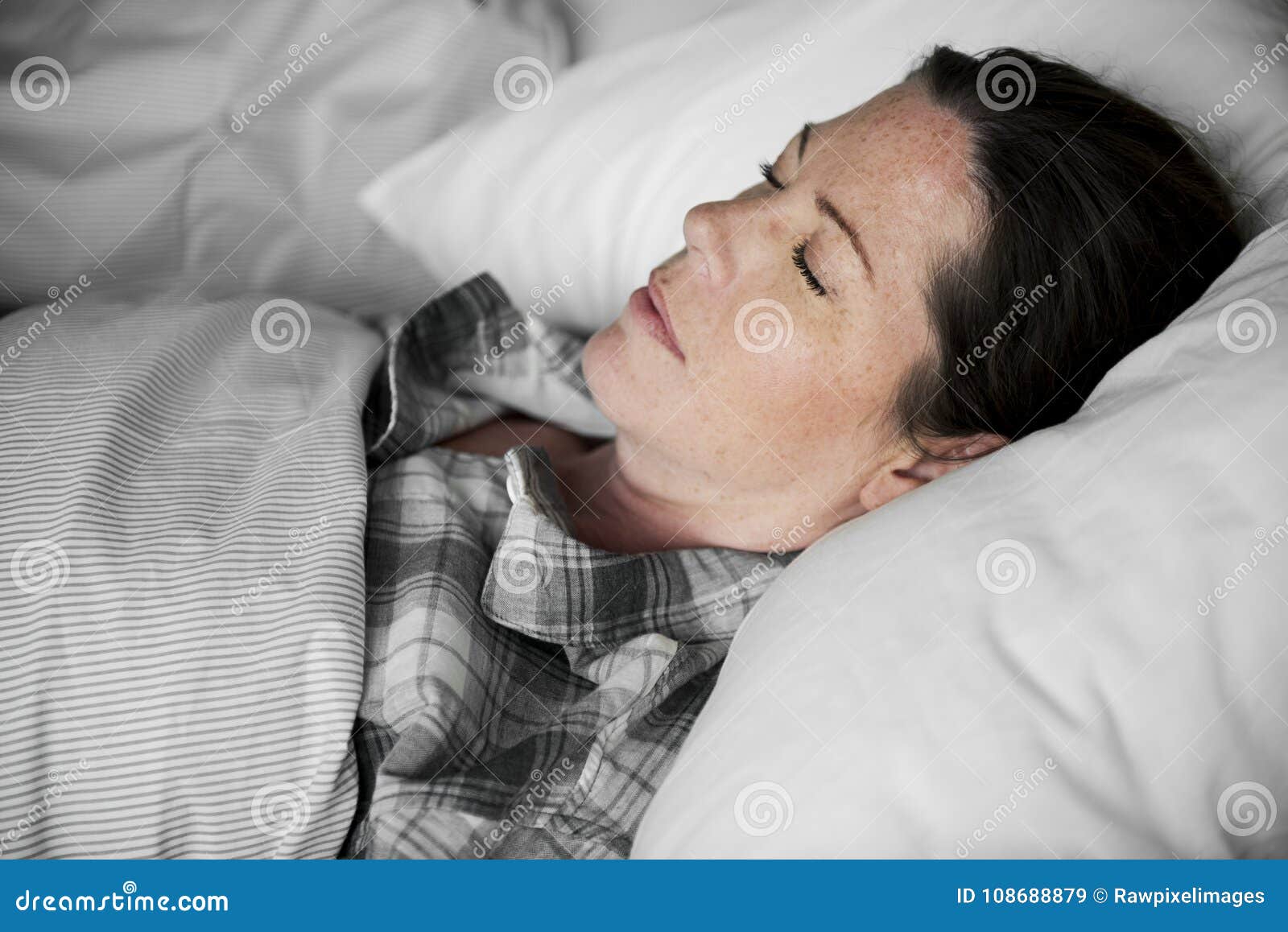 a woman sleeping soundly on bed