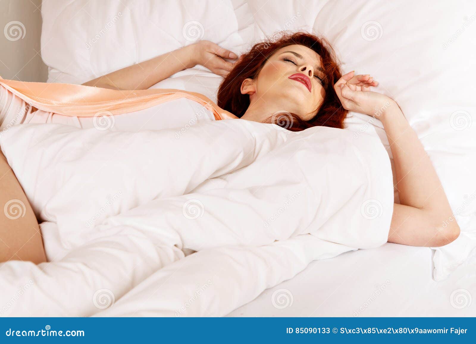 Woman Sleeping on the White Bedclothes in Bed at Home Stock Image