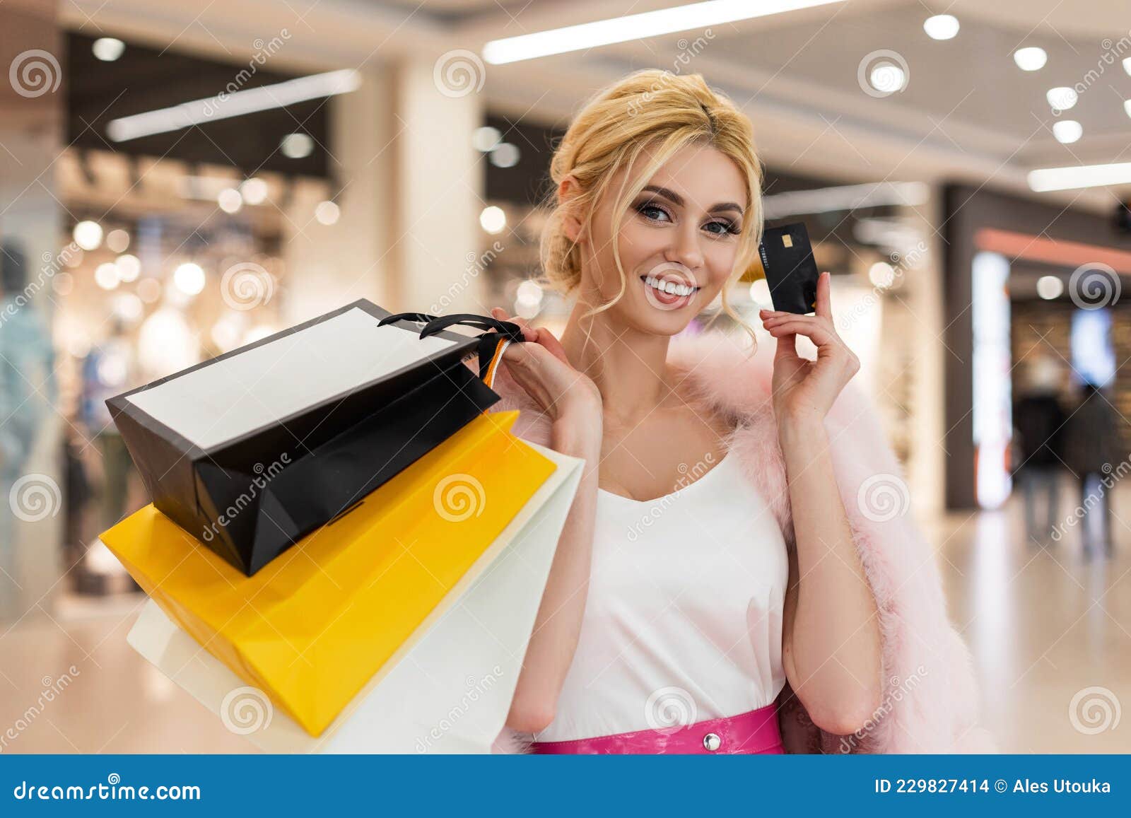 Woman with Smile in Luxurious Pink Fur Coat with Shopping Bags Holds a ...