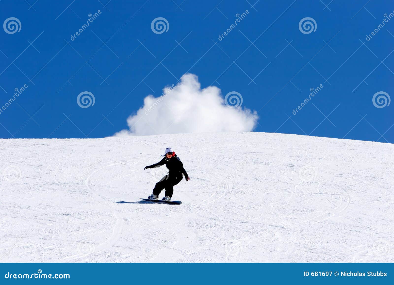 woman snowboarding on slopes of pradollano ski resort in spain
