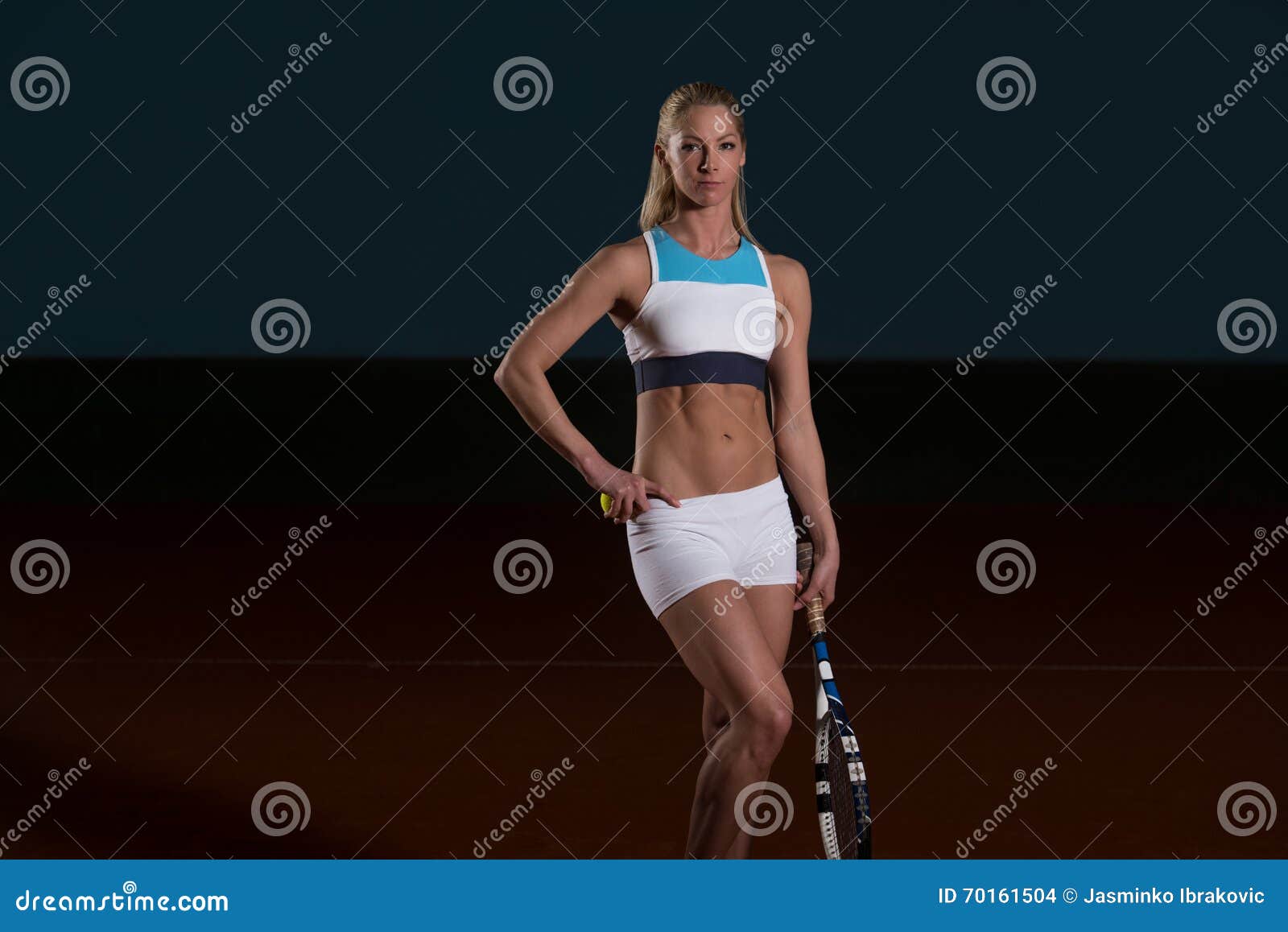 woman in sportswear serves tennis ball