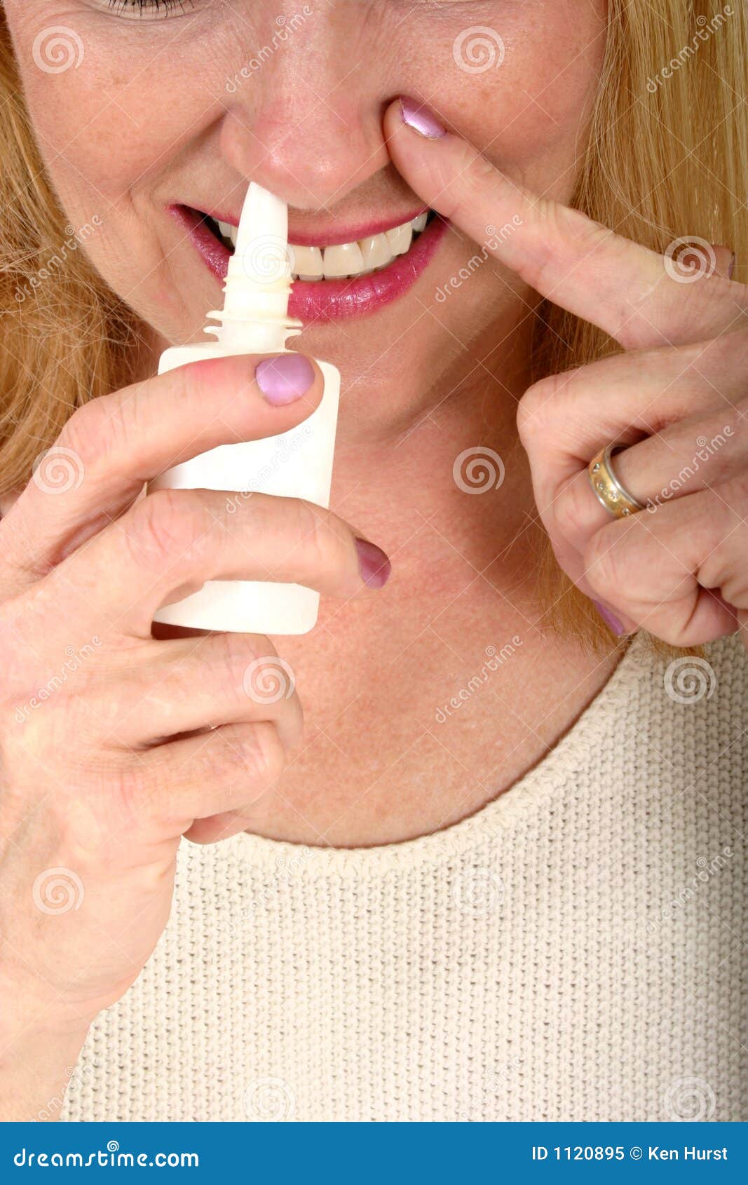 woman spraying nasal spray in nose 2