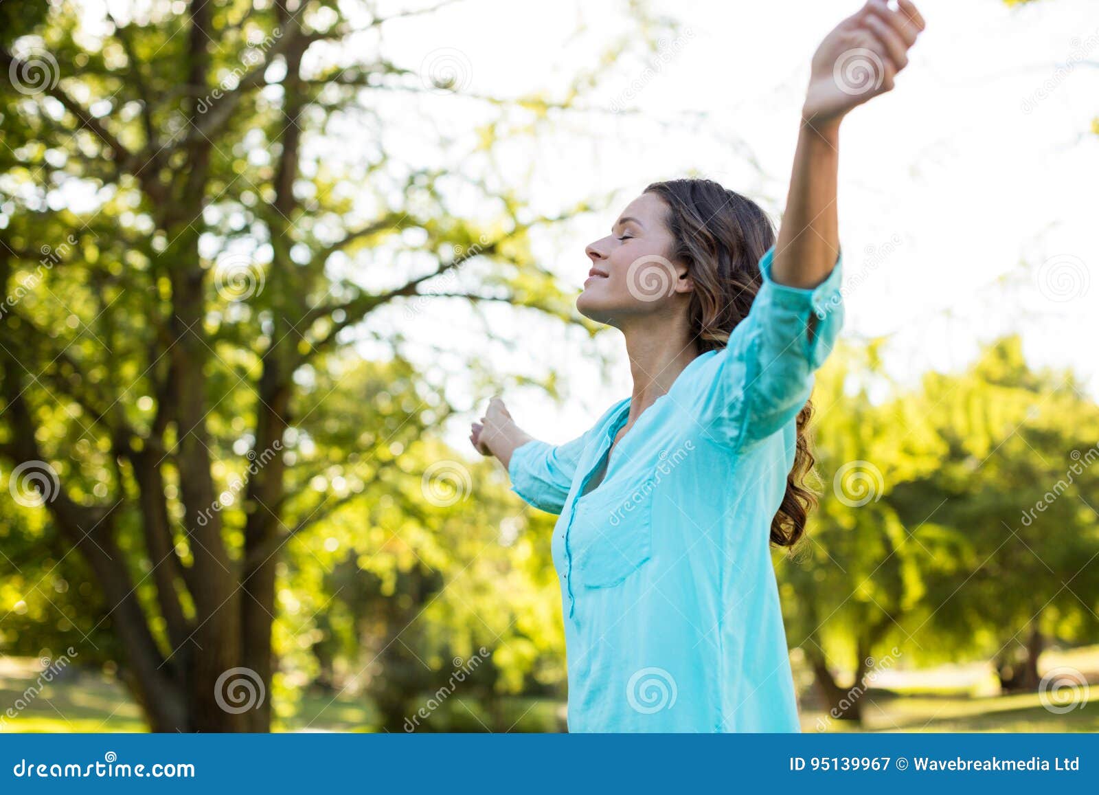 Woman Standing with Arms Outstretched in Park Stock Image Image of