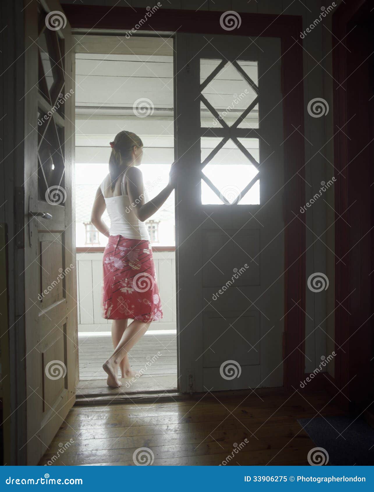 Exterior View Of The Open Front Door To A Residence With The