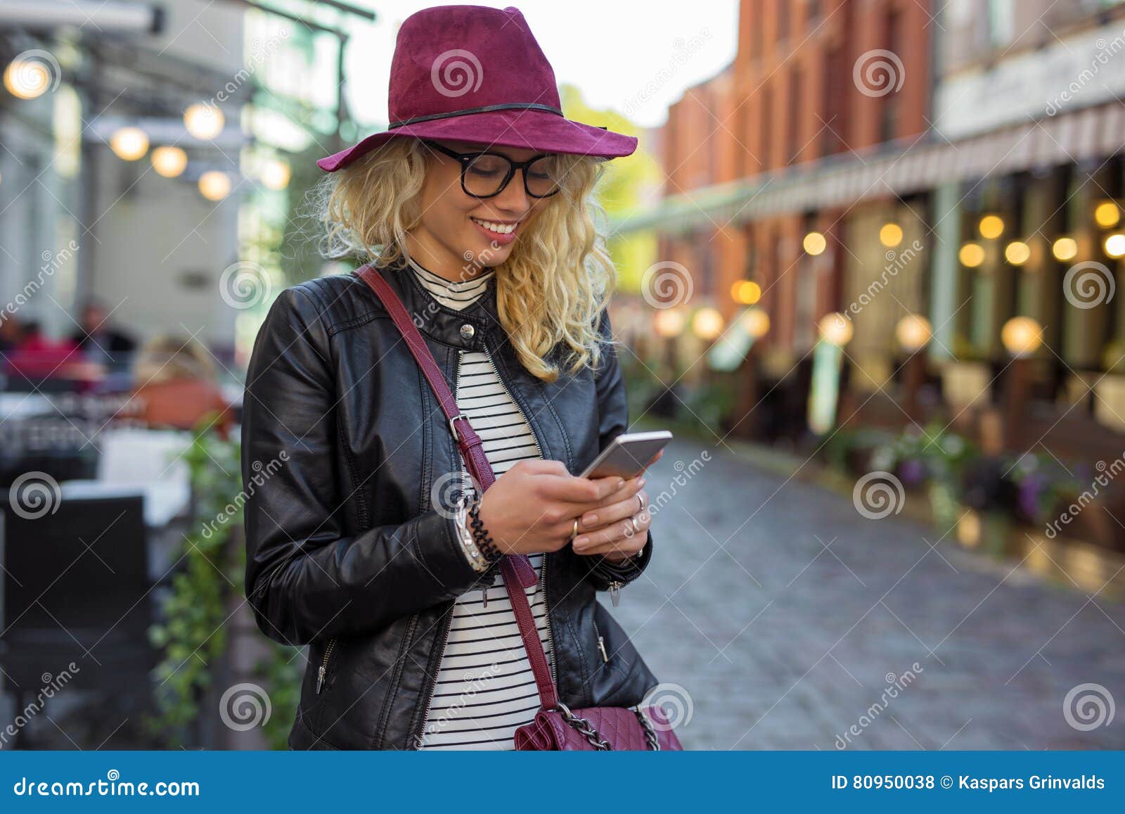 woman standing on the street and texting