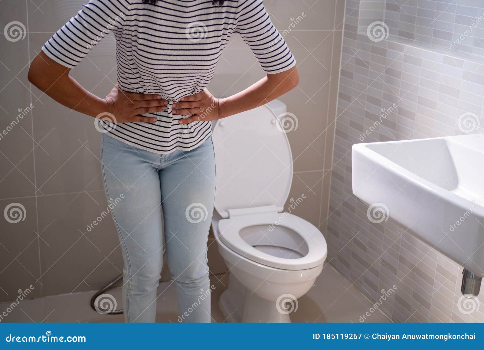Woman Stood In The Bathroom In The Toilet With Severe Diarrhea Use