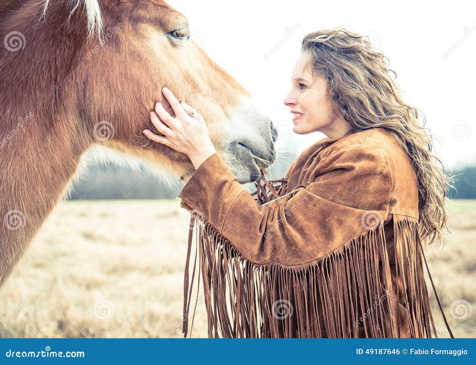 woman stroking horse