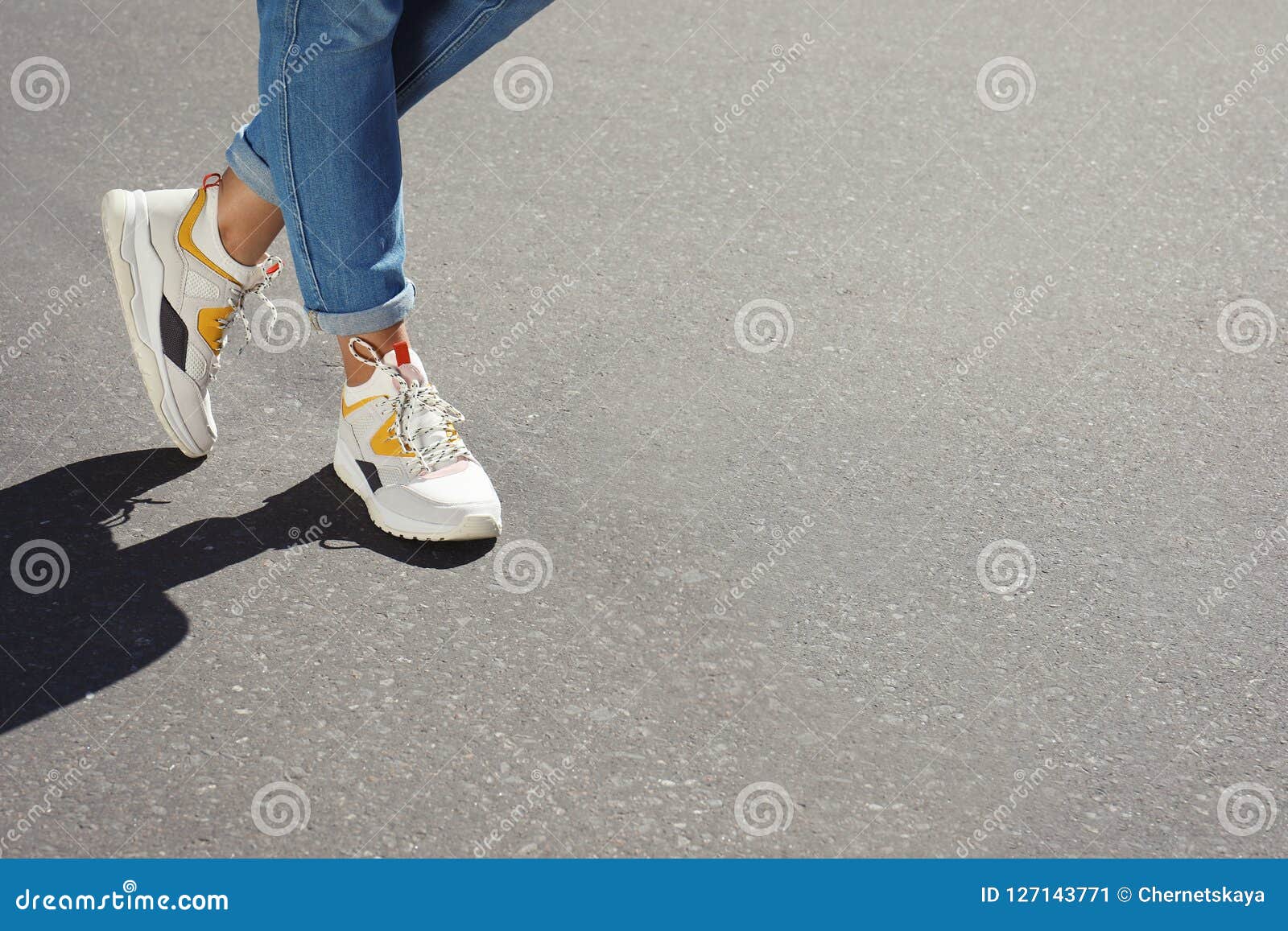 Woman in Stylish Sneakers Walking Outdoors, Focus on Legs. Stock Image ...