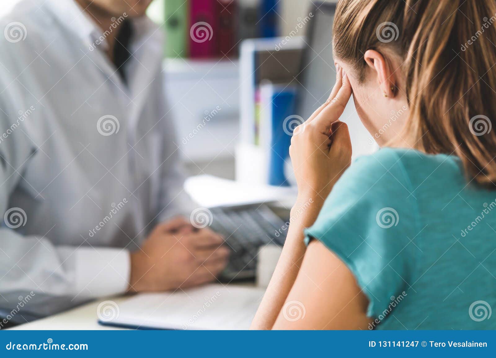 woman suffering from bad headache or migraine. appointment with doctor in office room.
