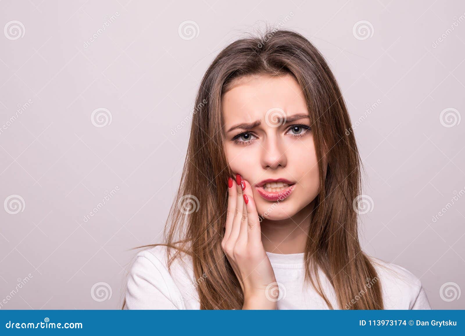 woman suffering from toothache, tooth decay or sensitivity  on gray