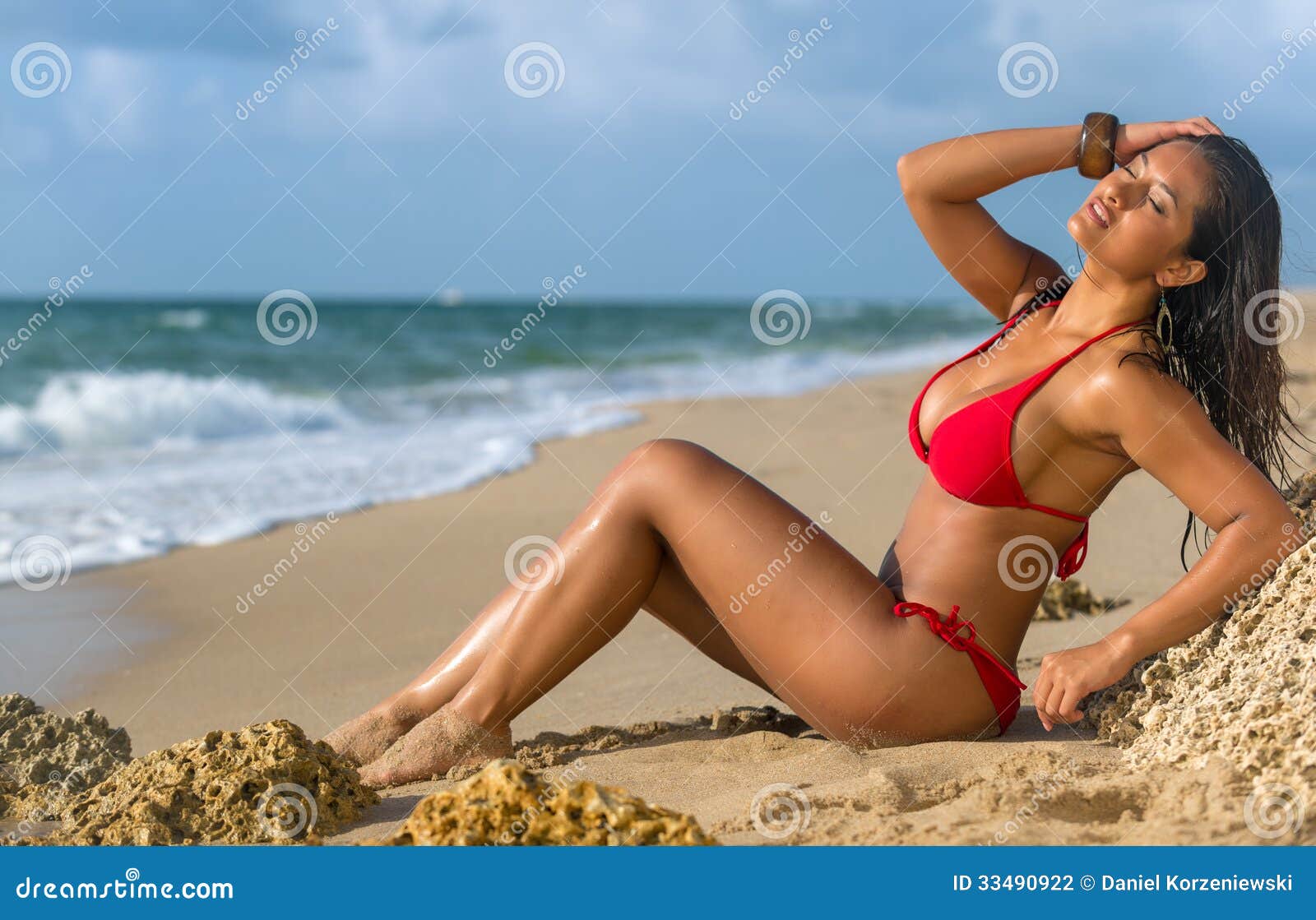 Woman Sunbathing at the Beach Stock Photo