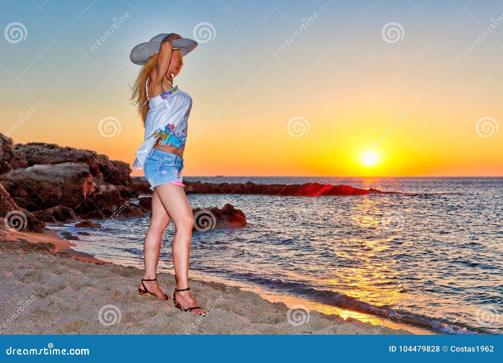 a woman at sunset on falassarna of creta, greece