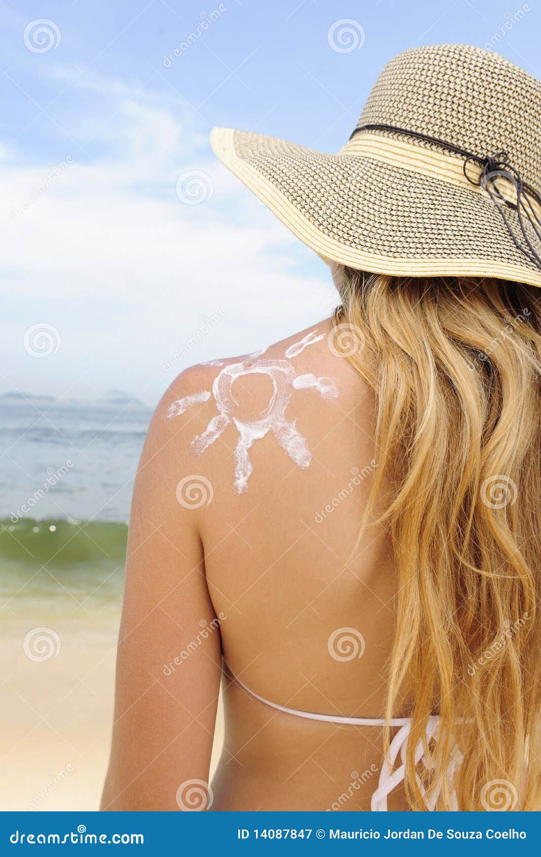 woman with suntan lotion at the beach