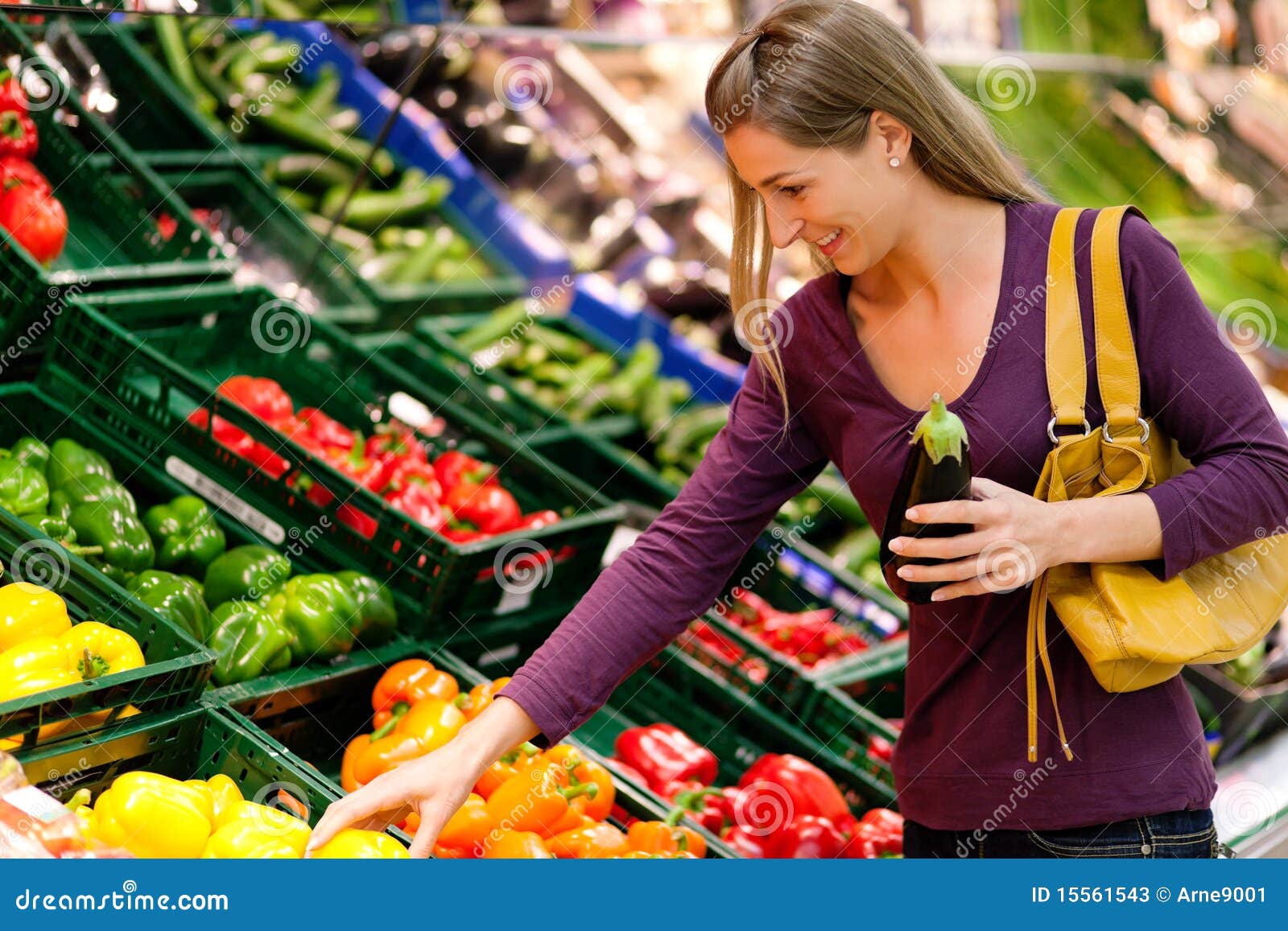 woman in supermarket buying groceries