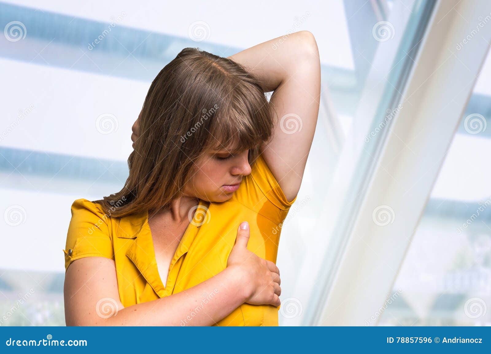 woman with sweating under armpit in yellow dress