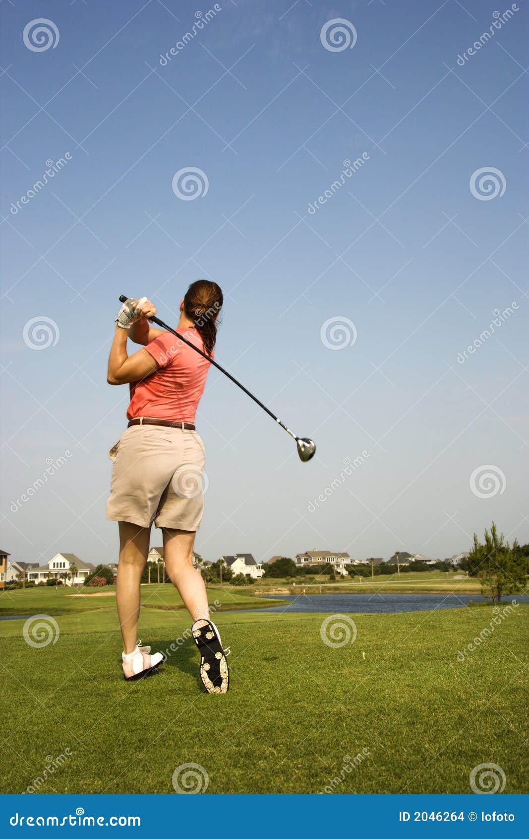 Woman swinging golf club. stock photo. Image of club, golf 2046264
