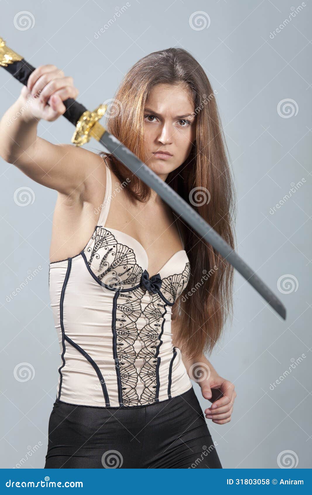 Pretty Girl With Sword Posing Over Dark Background Stock Photo, Picture and  Royalty Free Image. Image 40760145.