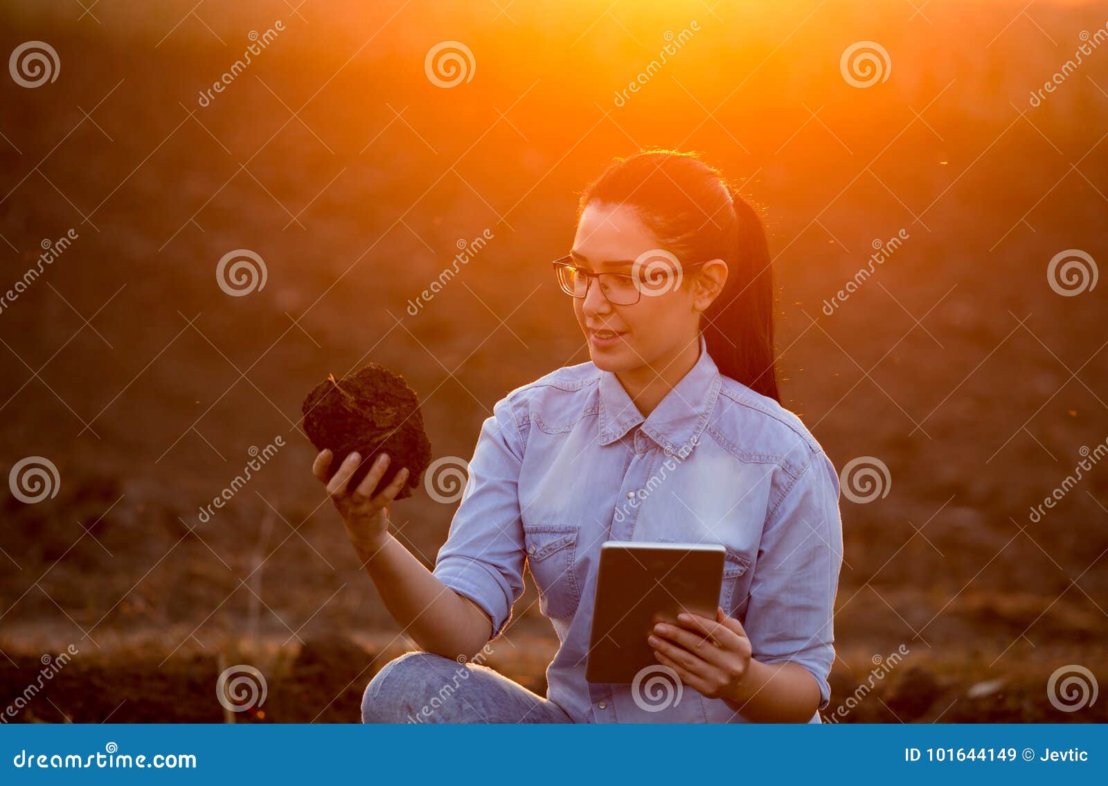 woman with tablet and earth clod