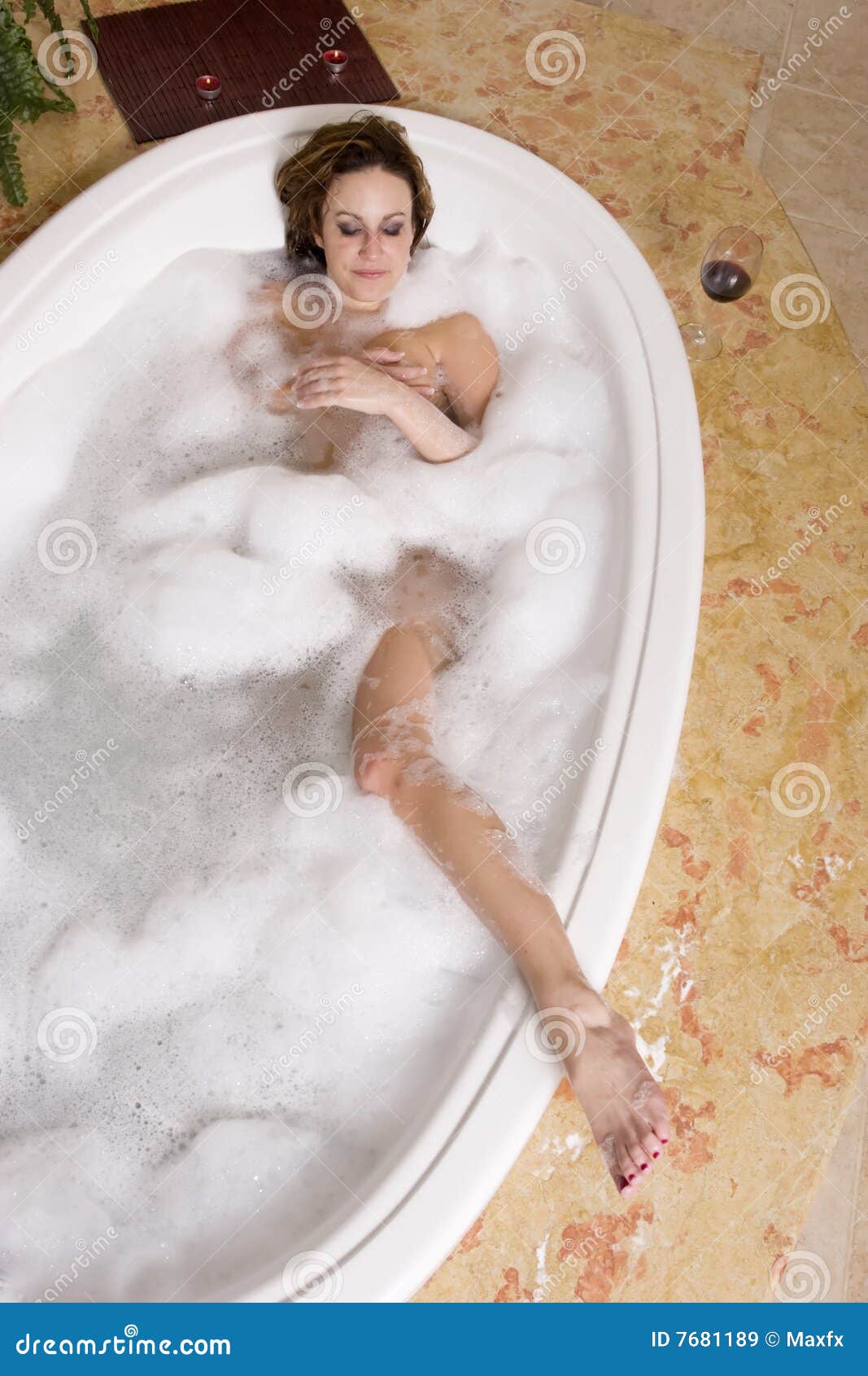 Woman Taking A Bubble Bath At Her Home