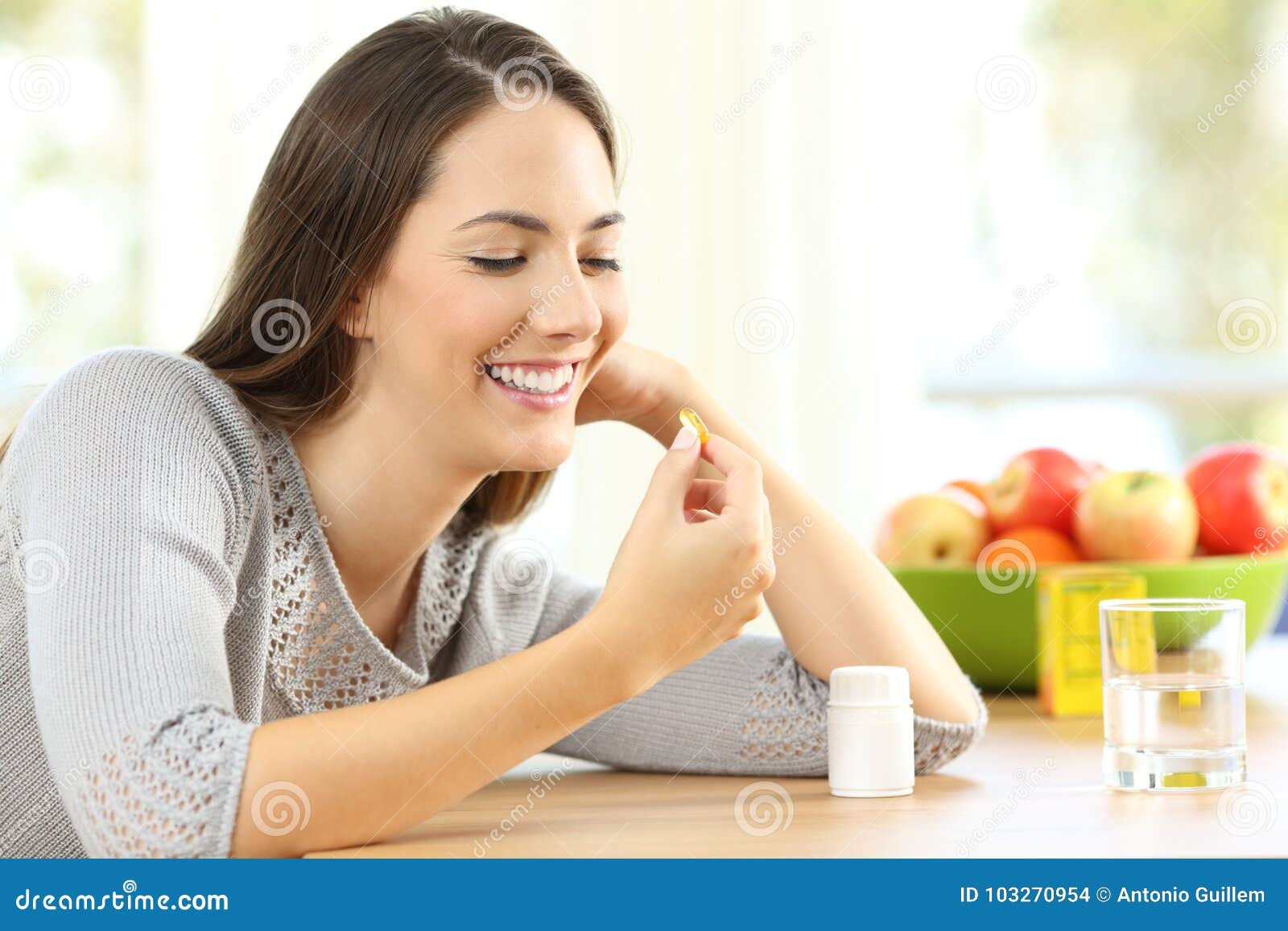 woman taking omega 3 vitamin pills