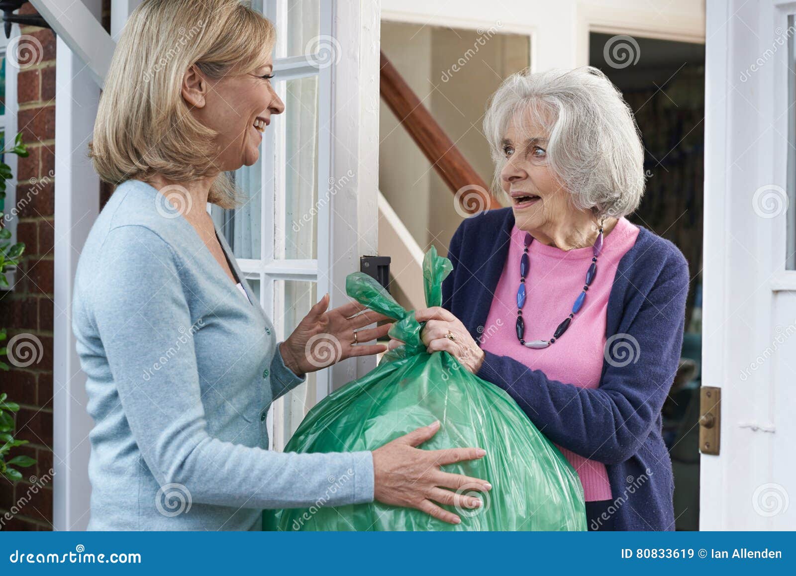 woman taking out trash for elderly neighbour