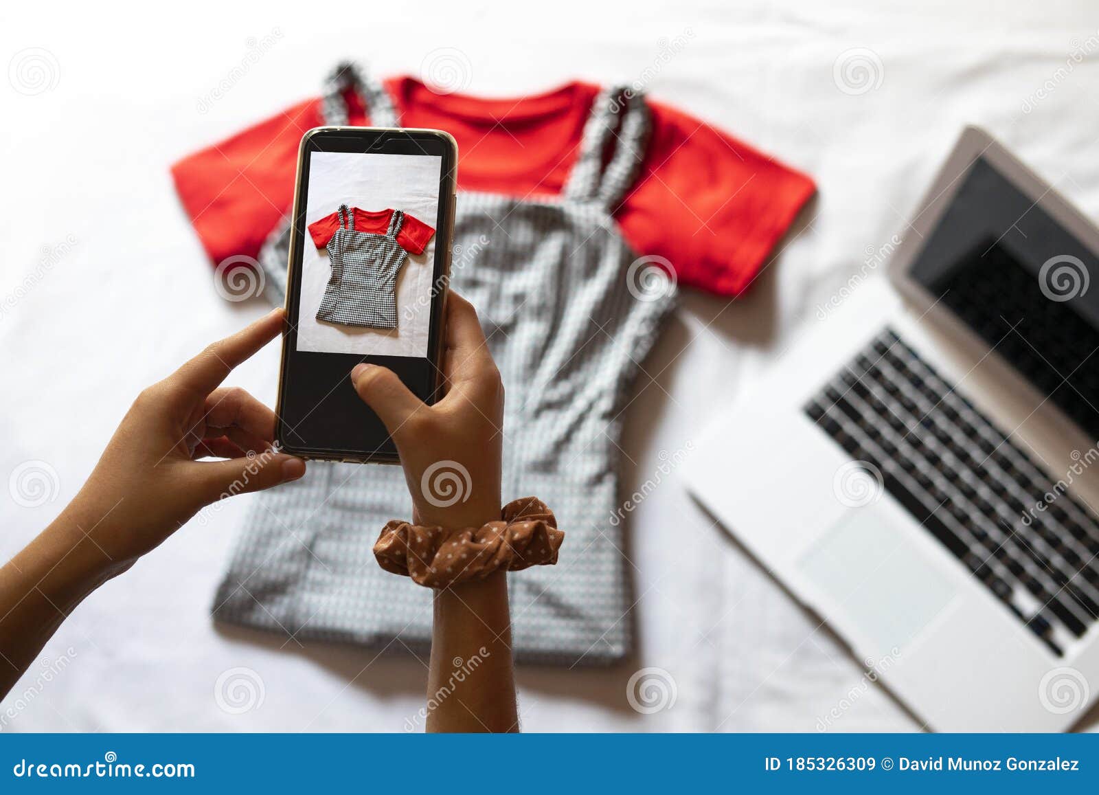 woman taking a photo of an article of clothing to sell online. concept of selling clothes online.