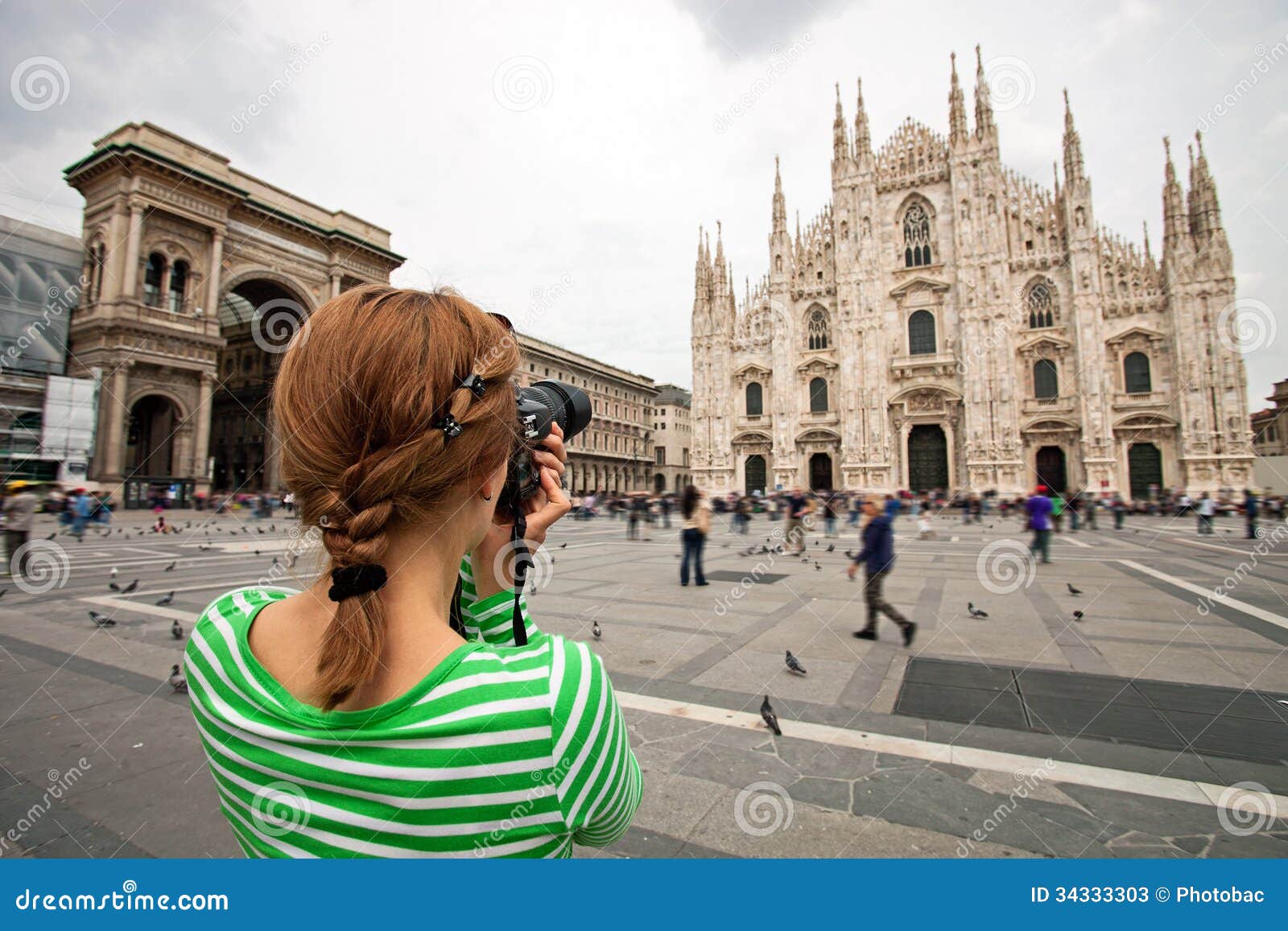 woman taking picture of duomo di milano, italy