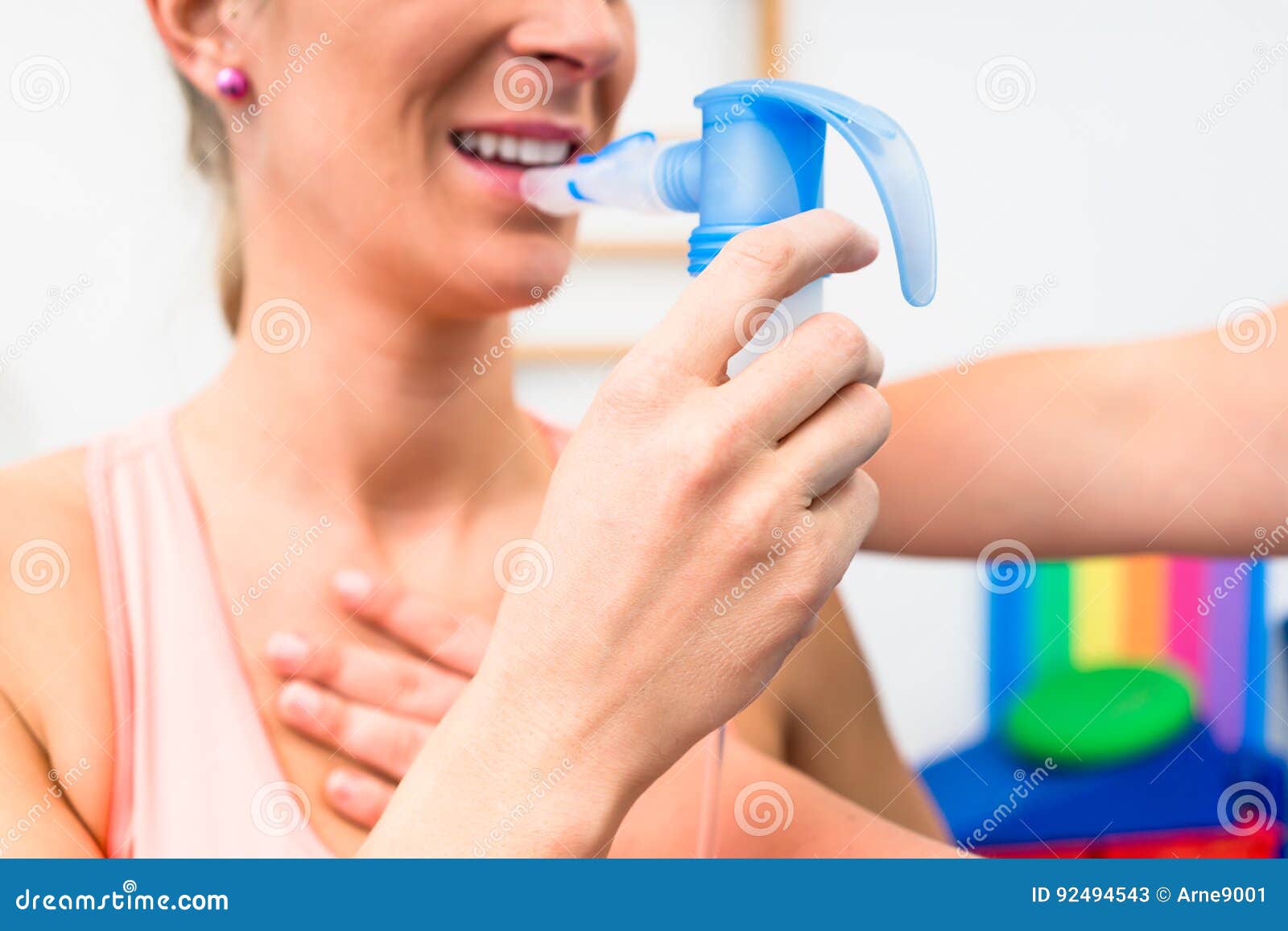 woman taking pulmonary function test with mouthpiece in her hand