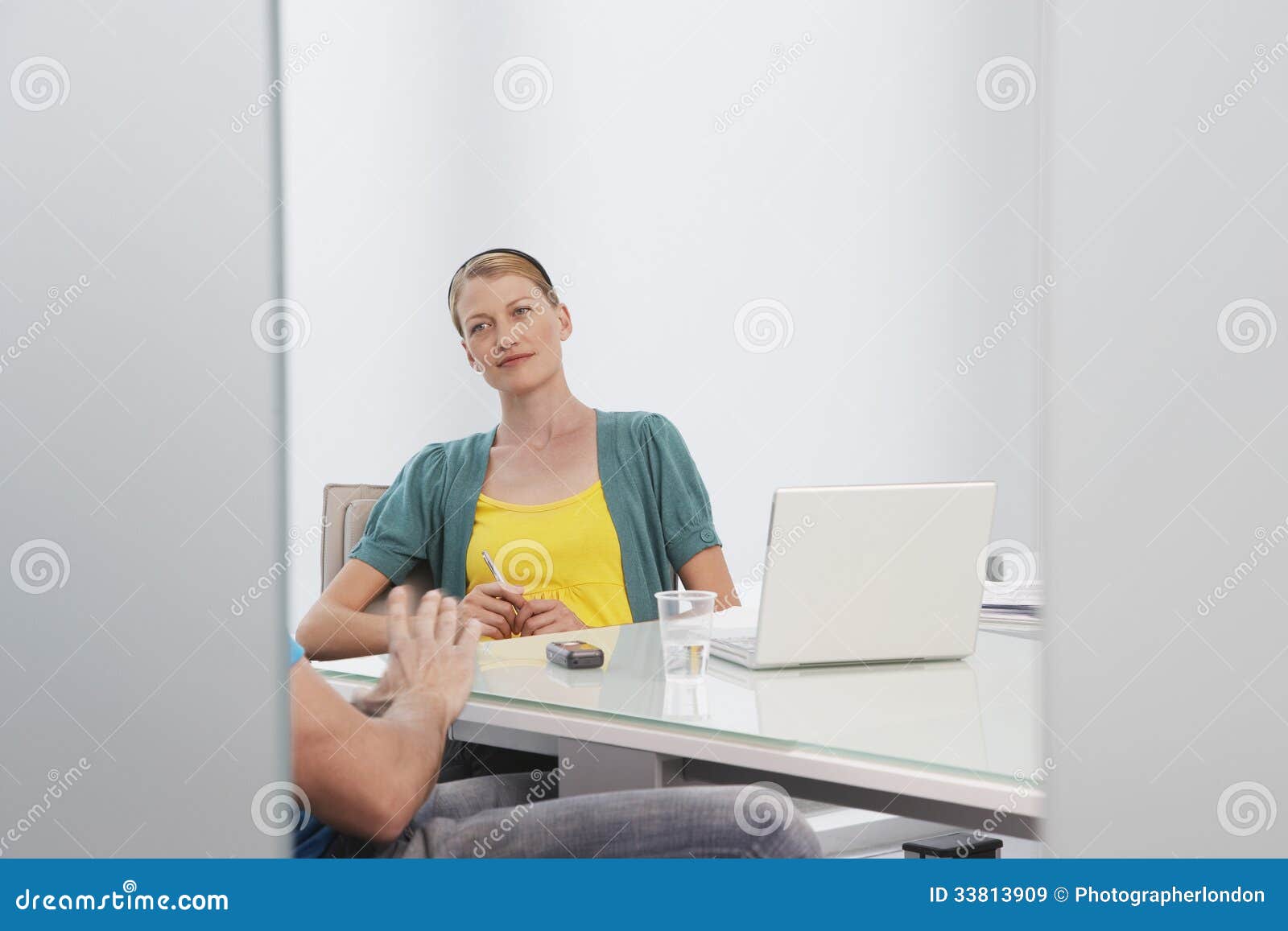 woman talking to cropped colleague in office