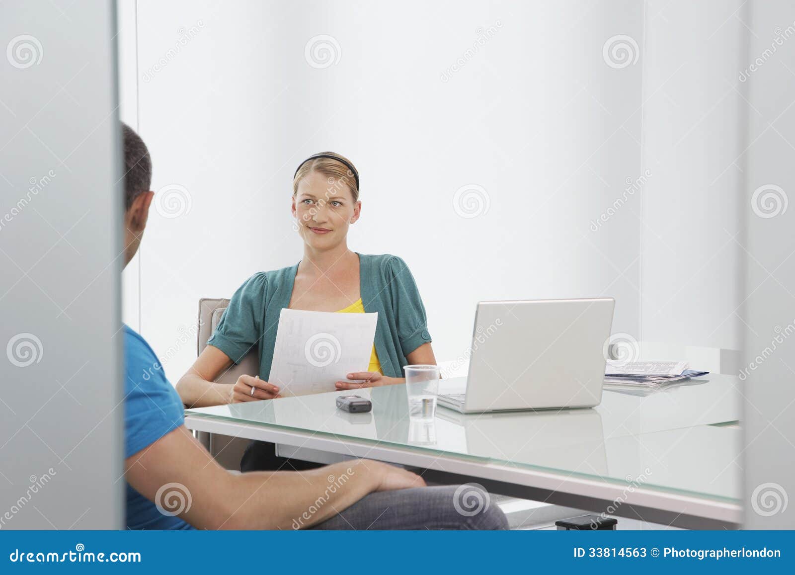 woman talking to cropped colleague in office