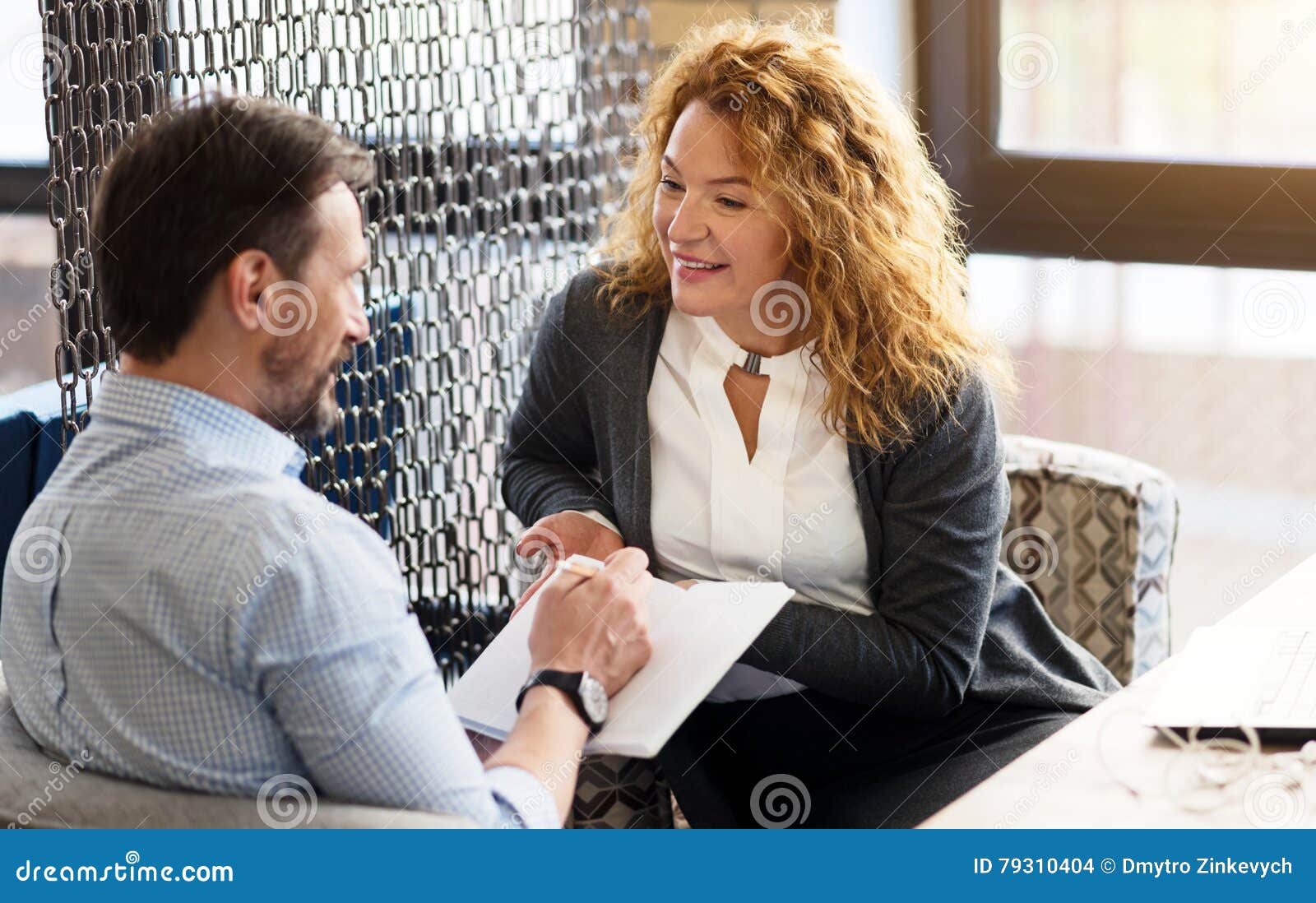 https://thumbs.dreamstime.com/z/woman-talking-to-man-taking-notes-describing-new-concept-pretty-red-haired-women-men-sitting-against-big-79310404.jpg