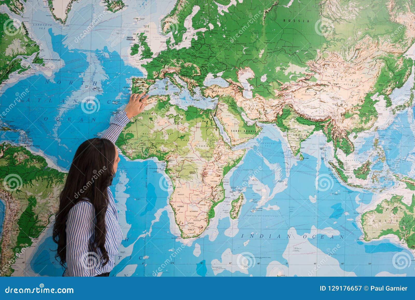 woman teaching geography in world map