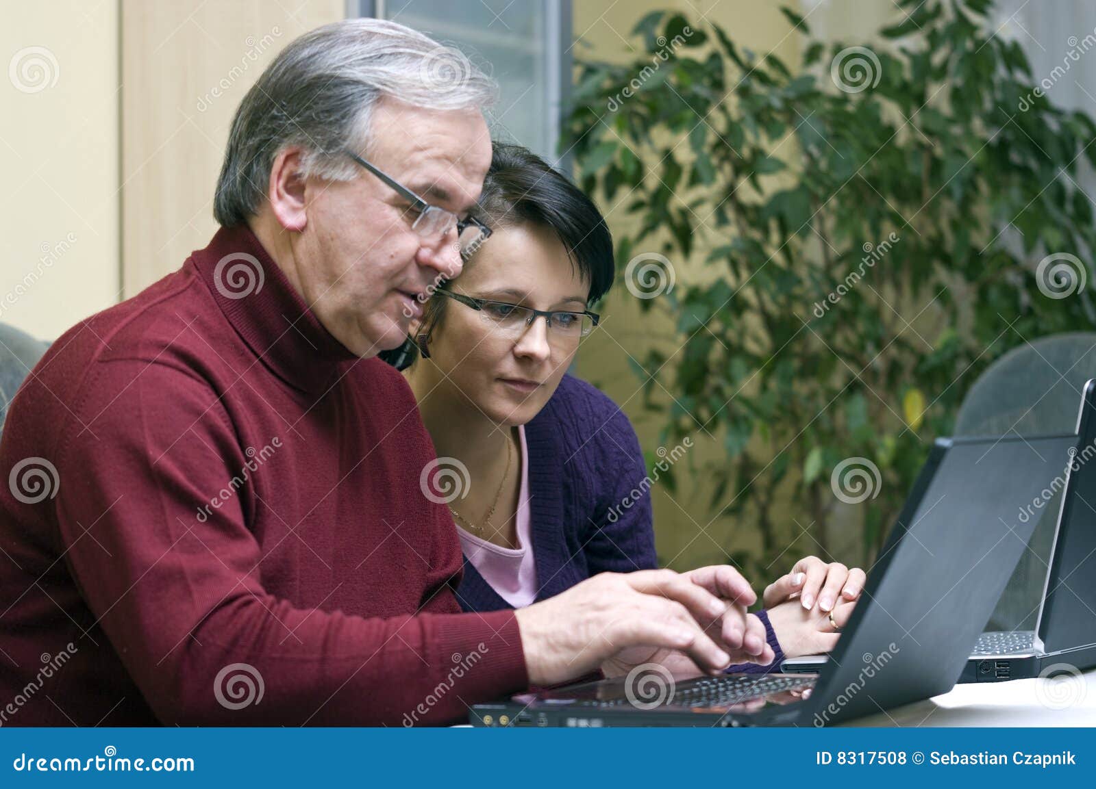woman teaching senior use of computers