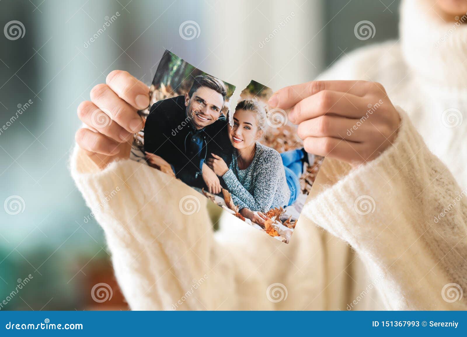 woman tearing up photo of happy couple, closeup. concept of divorce