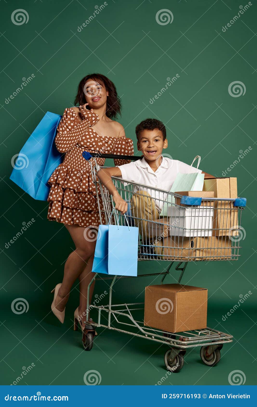 Portrait of Woman and Teen Boy Sitting in Shopping Trolley with Many ...