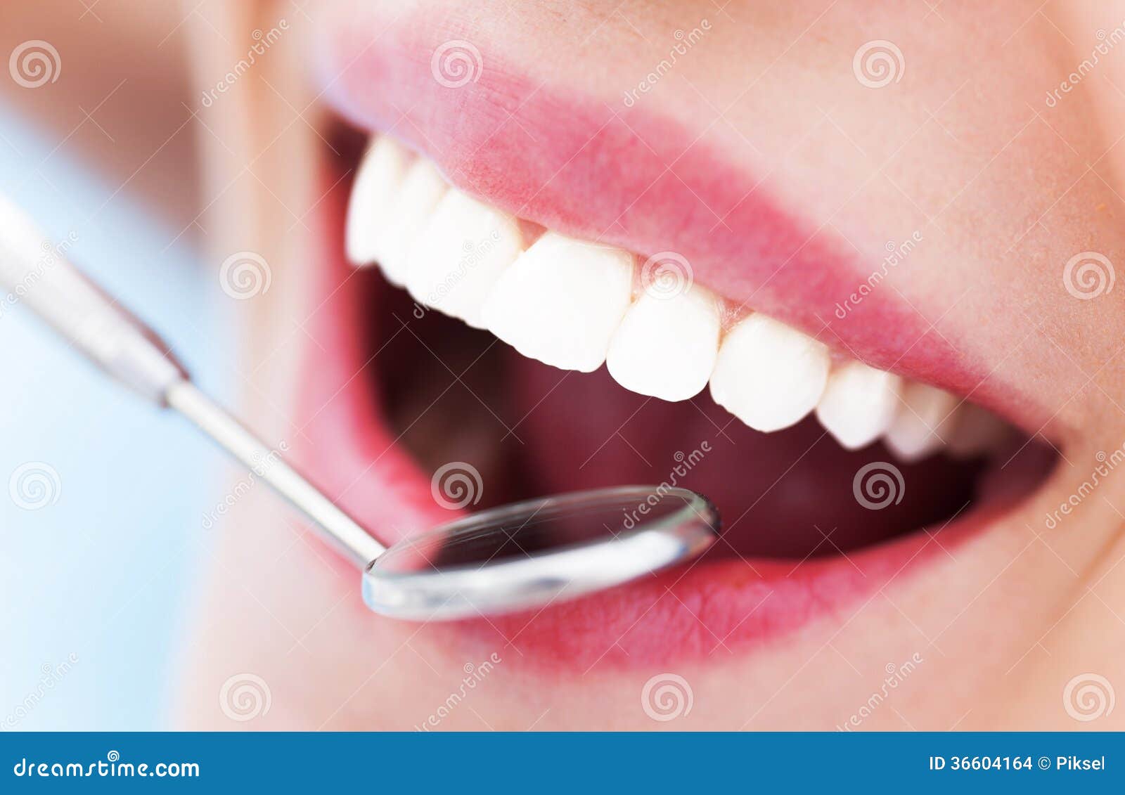 woman teeth and a dentist mirror