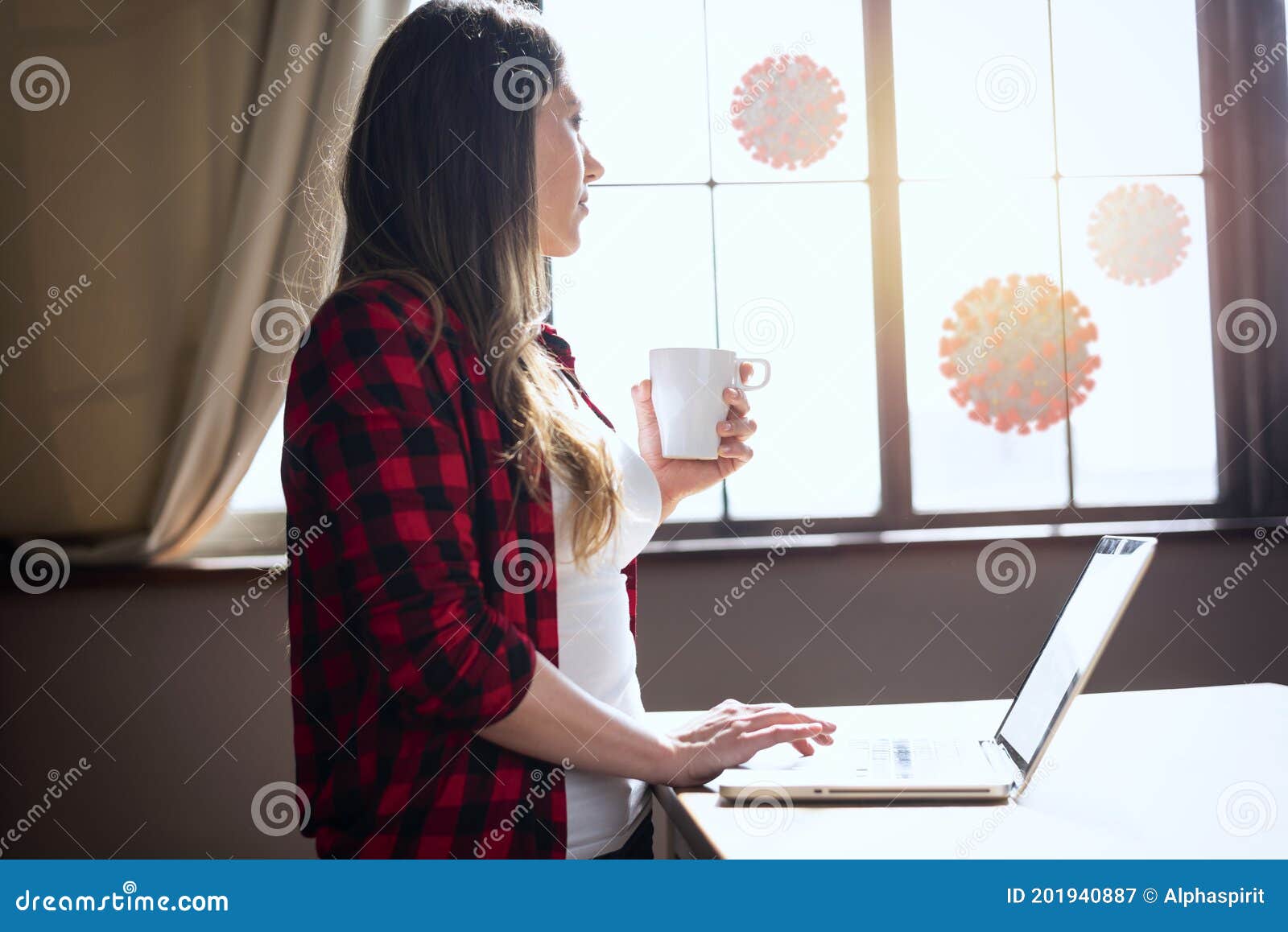 woman teleworker works at home with a laptop. she is in smart working because outside is full of covid 19 coronavirus