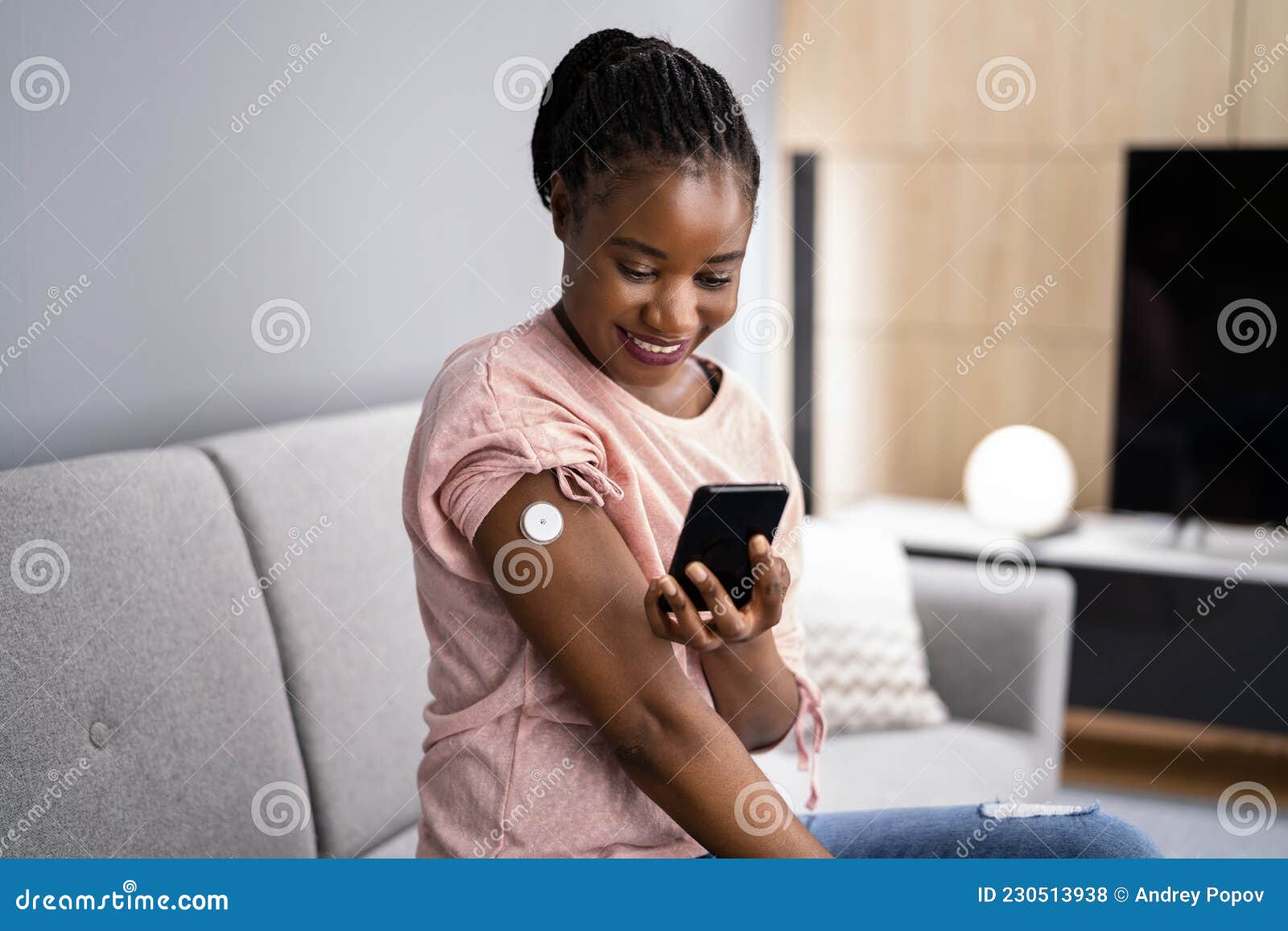 woman testing glucose level with continuous glucose monitor