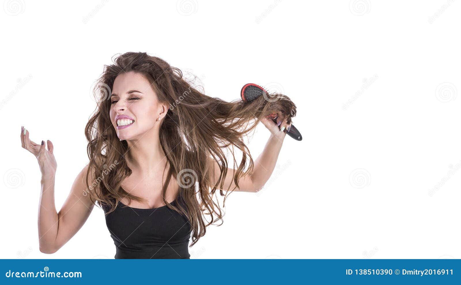 woman with thick brown tangled hair try to comb hairs but fail. hair healt concept.